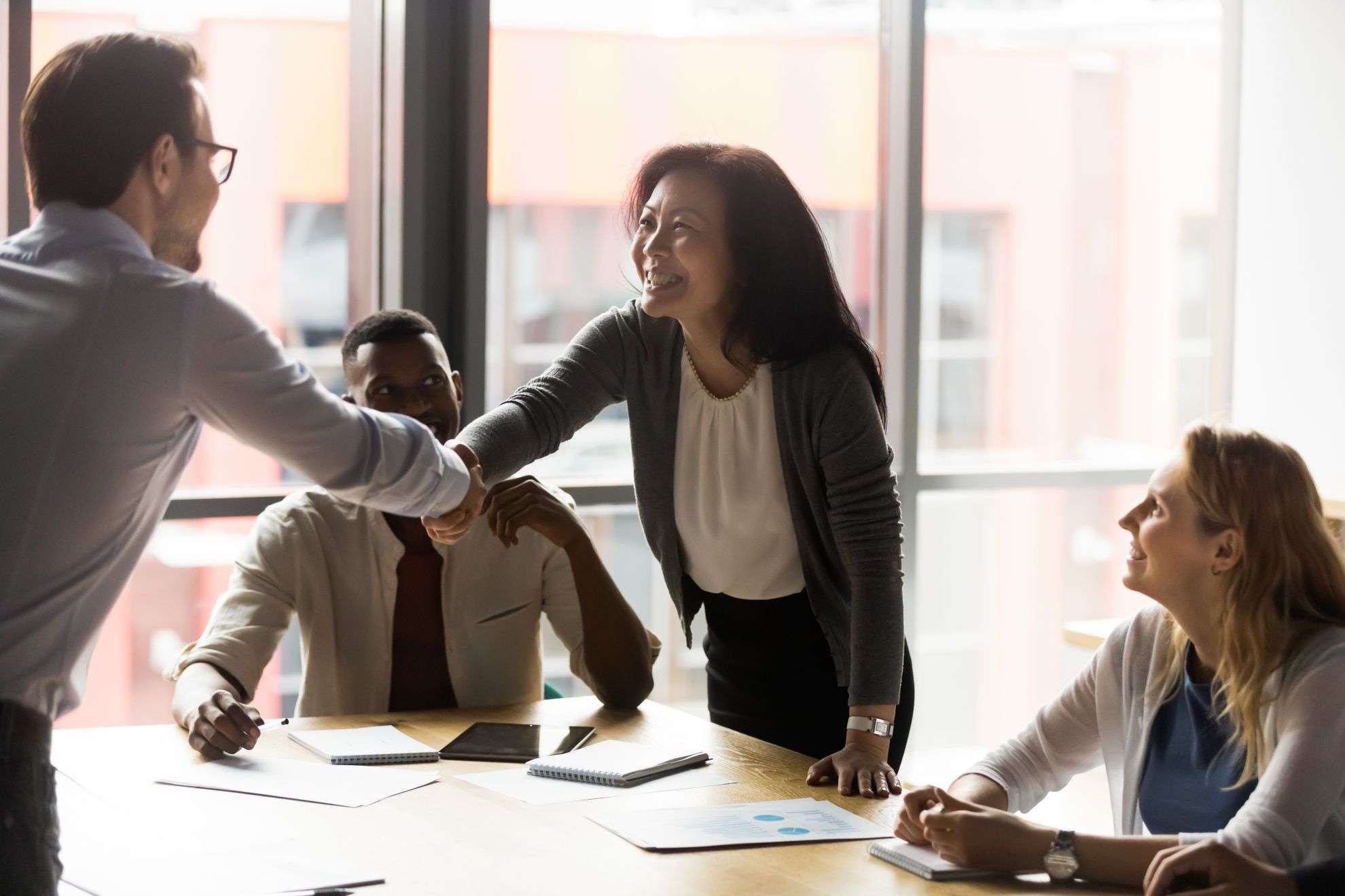 stock-photo-middle-aged-asian-korean-ethnicity-businesswoman-shake-hands-with-european-millennial-client-in-1751484302
